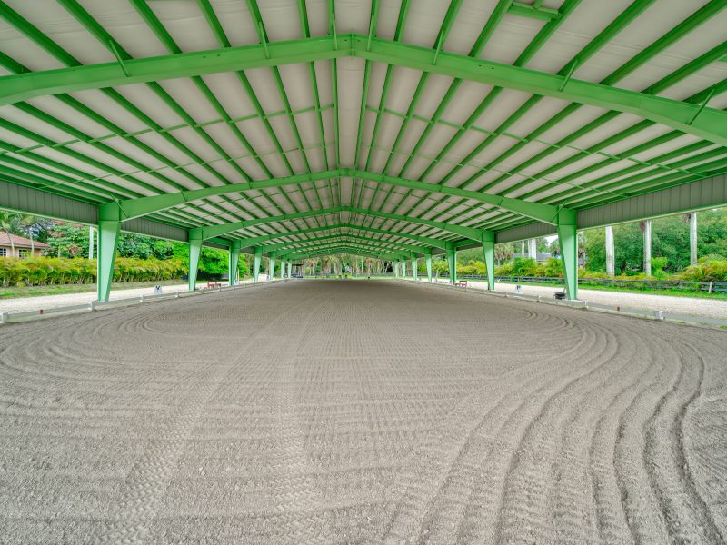 Indoor roof only green riding arena metal building in Florida