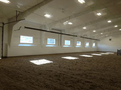 Steel building interior with windows, riding arena