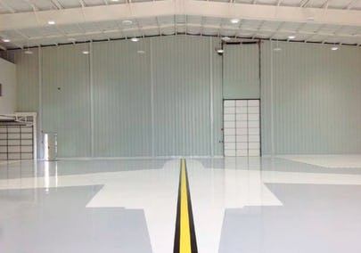 Steel building with interior PBR liner panel and shiny tiled floor.